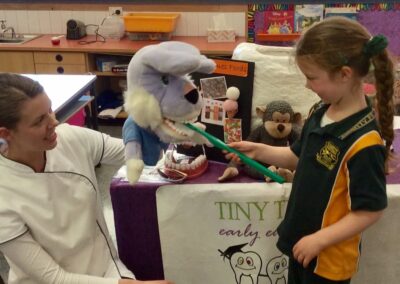 Dental Educator Engaging with K-2 Aged Student